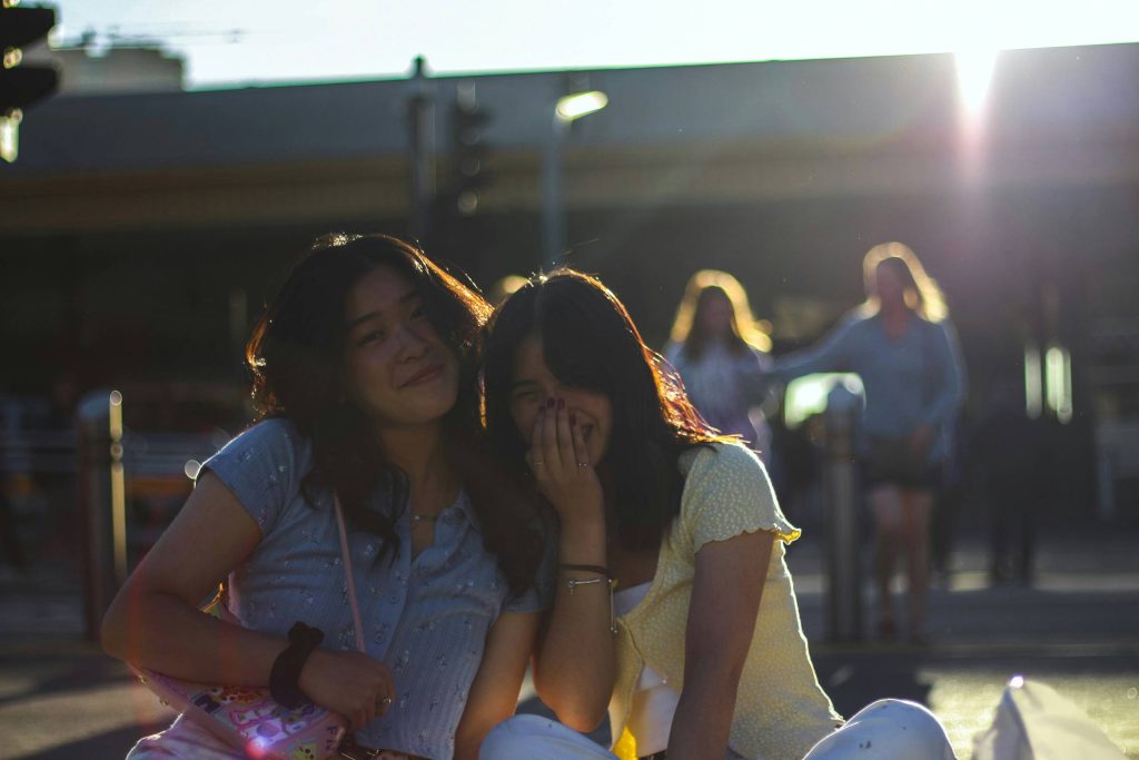 Two students relaxing together in a campus setting