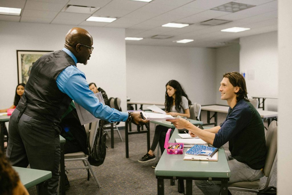 A teacher interacting with student in the classroom