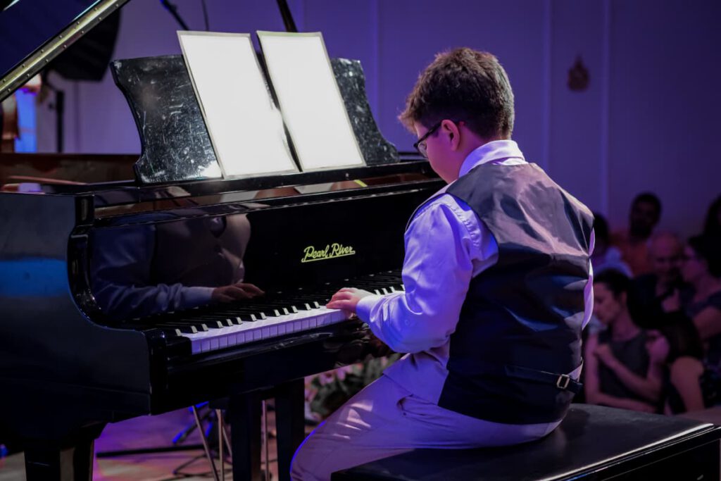 a student performs at a piano recital