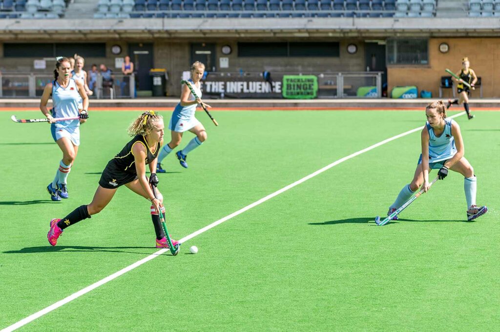 Girls field hockey team playing a game