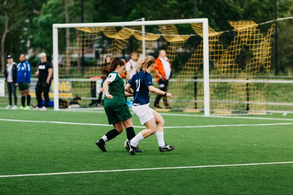 Two students playing soccer
